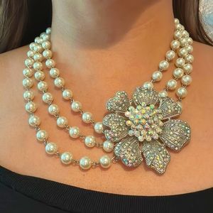 Costume jewelry pearl necklace with large flower